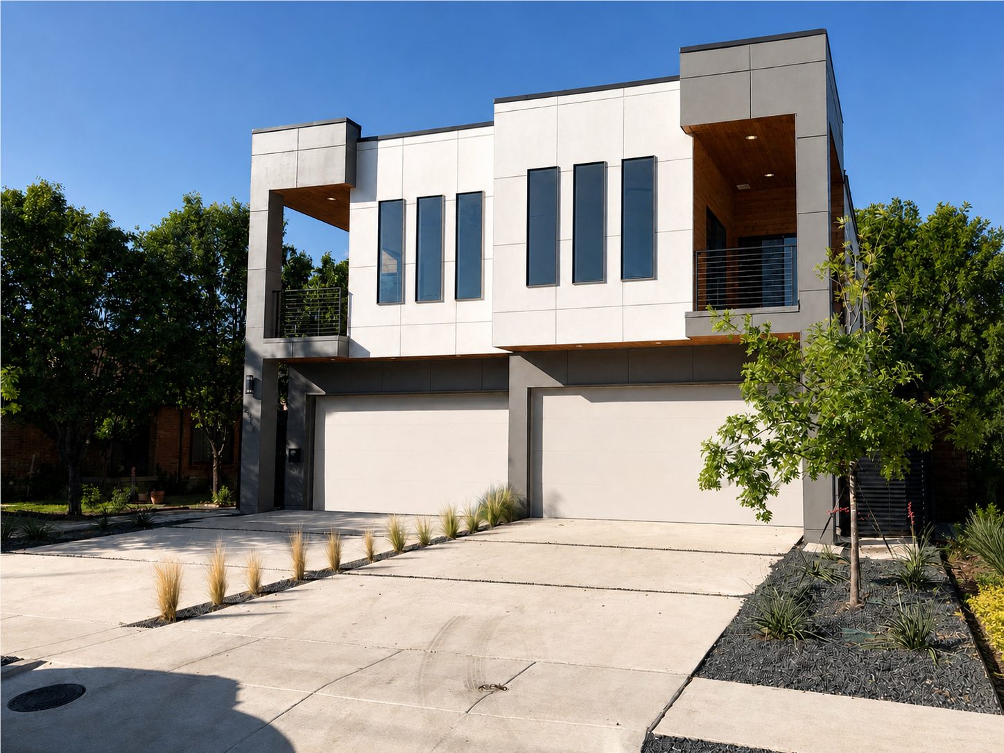 Modern multi-story residence with white panels and charcoal trim